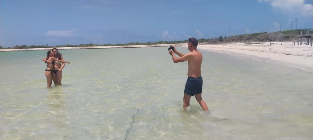 Rio Lagartos Beach: A Hidden Paradise of White Sand and Turquoise Waters in Yucatan 8 Guests capturing memories and enjoying a photo opportunity in the shallow, turquoise waters during our guided Río Lagartos boat tour.