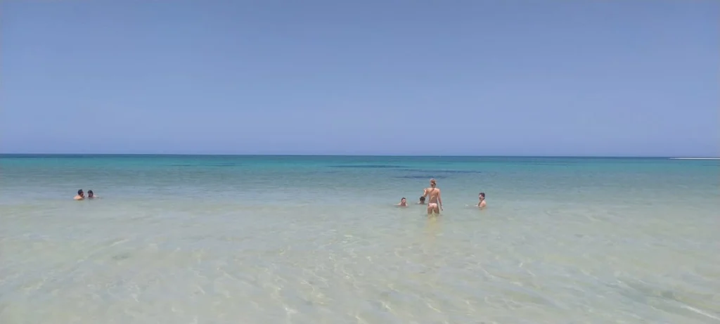Rio Lagartos Beach: A Hidden Paradise of White Sand and Turquoise Waters in Yucatan 9 Tour group swimming in the stunningly clear and shallow turquoise waters of the Río Lagartos Biosphere, an unforgettable experience on our boat tour.