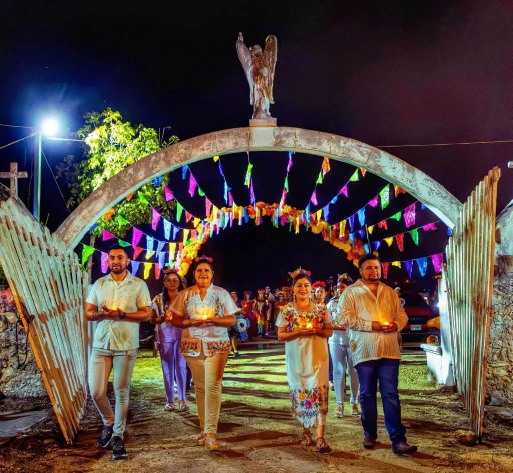 Traditional Paseo de las Animas procession in Rio Lagartos with people wearing white guayaberas and holding candles.