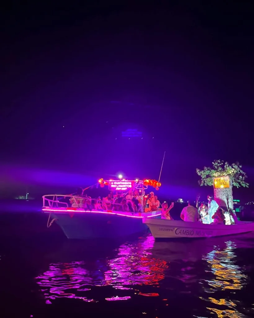 Illuminated boat tour participating in the night festival on the Rio Lagartos estuary biosphere reserve.