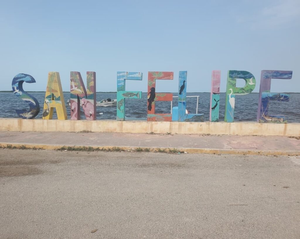 Rio Lagartos Travel Guide 2026: The Perfect Full Day Itinerary Beyond the Flamingos 17 The iconic colorful San Felipe Sign on the waterfront boardwalk, highlighted as a top recommendation in the Rio Lagartos Travel Guide and Rio Lagartos Day Trip Guide for exploring the Yucatan coast.